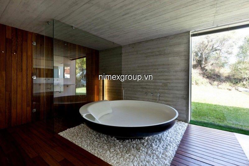 roung-bathtub-design-with-glass-shower-space-and-wood-floor-and-white-gravel-decor-for-contemporary-bathroom-design.jpg